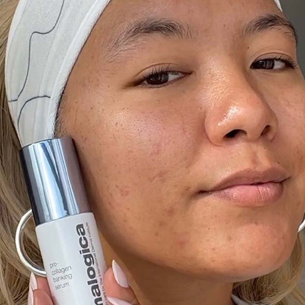 Woman holding a dermalogica pro-collagen banking serum to her face